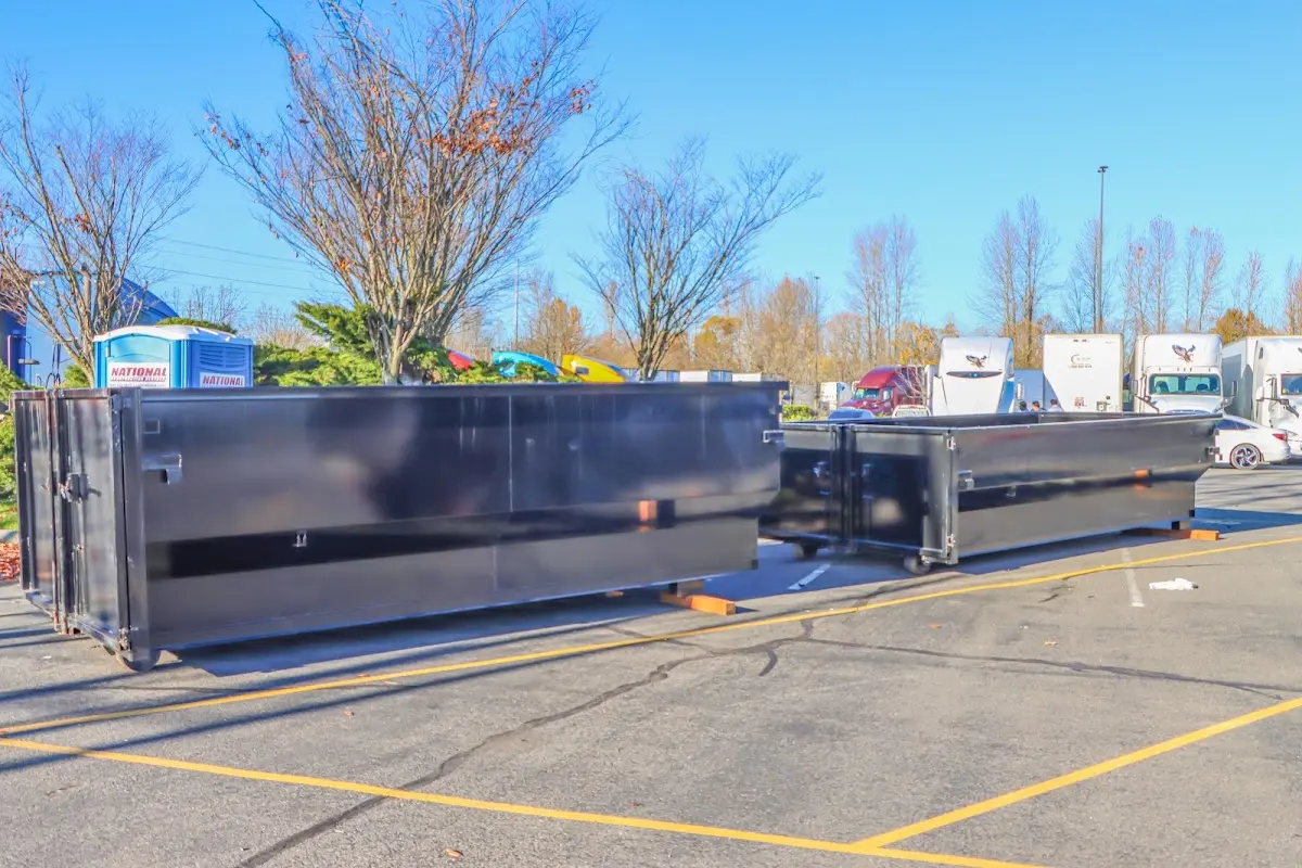 Professional dumpster rental service with roll-off container on residential driveway in Attleboro